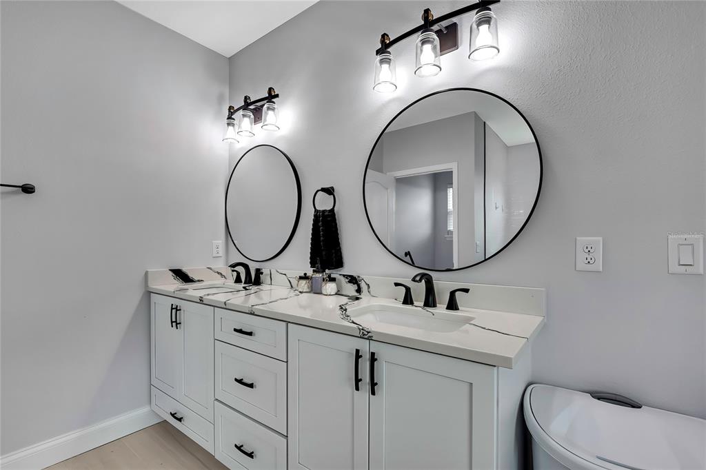 3276 Sea Grape Drive Hernando Beach, FL 34607 - Photo 20 of 55 a bathroom with a toilet a sink and a mirror