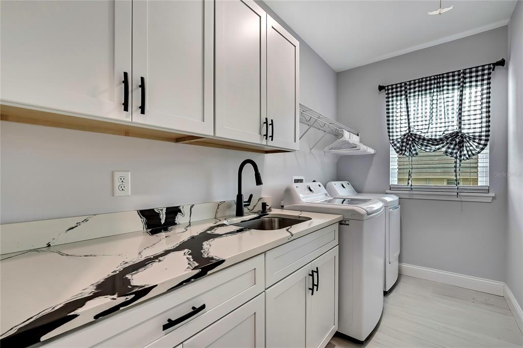 3276 Sea Grape Drive Hernando Beach, FL 34607 - Photo 24 of 55 a kitchen with stainless steel appliances granite countertop a sink and a white cabinets