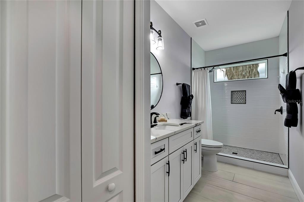 3276 Sea Grape Drive Hernando Beach, FL 34607 - Photo 26 of 55 a spacious bathroom with a double vanity sink and mirror