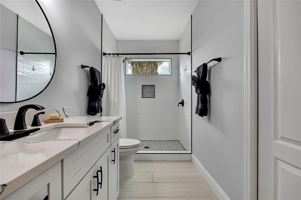 3276 Sea Grape Drive Hernando Beach, FL 34607 - Photo 27 of 55 a bathroom with a sink a toilet and a mirror