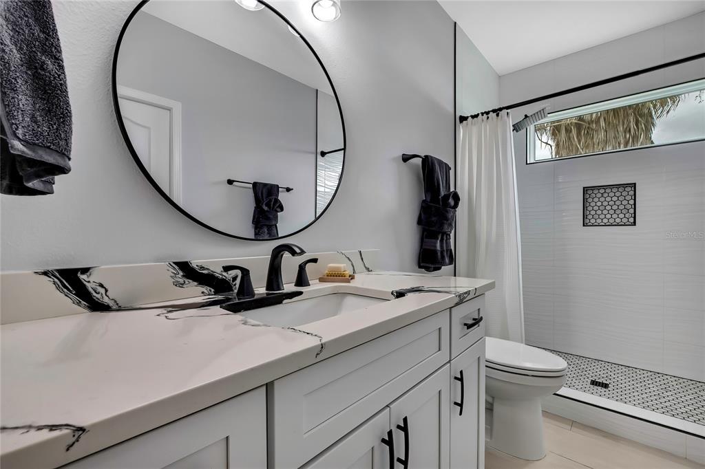 3276 Sea Grape Drive Hernando Beach, FL 34607 - Photo 28 of 55 a bathroom with a toilet sink and mirror