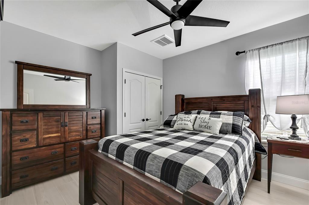 3276 Sea Grape Drive Hernando Beach, FL 34607 - Photo 29 of 55 a bedroom with a bed and a flat tv screen on dresser