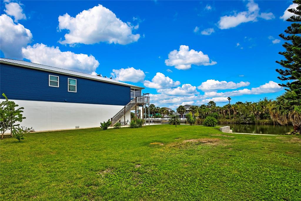 3276 Sea Grape Drive Hernando Beach, FL 34607 - Photo 42 of 55 a view of a big yard with potted plants
