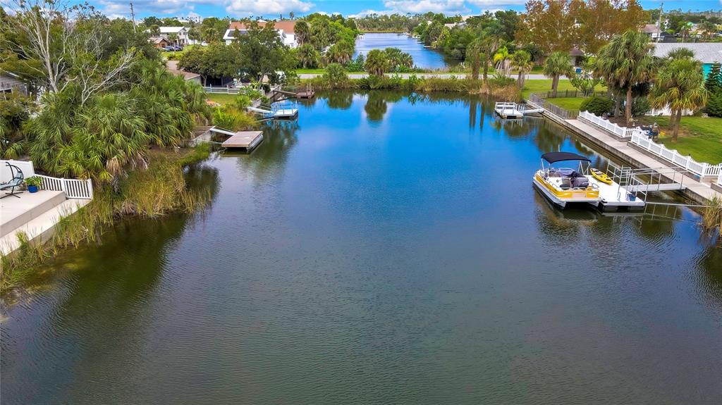 3276 Sea Grape Drive Hernando Beach, FL 34607 - Photo 46 of 55 a view of a lake with boats and trees in the background