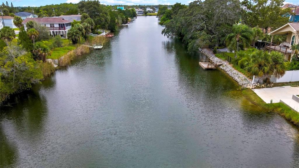 3276 Sea Grape Drive Hernando Beach, FL 34607 - Photo 47 of 55 an aerial view of a house with a yard and lake view