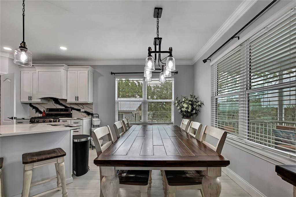 3276 Sea Grape Drive Hernando Beach, FL 34607 - Photo 10 of 55 a kitchen with a table chairs stove and cabinets