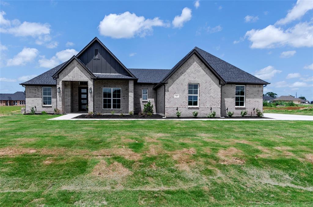 a front view of house with yard and green space