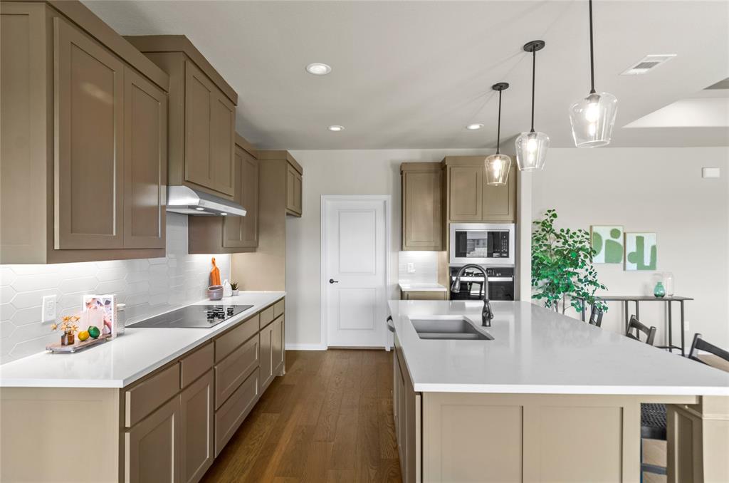 205 Stuart Paradise, TX 76073 - Photo 12 of 33 a kitchen that has a lot of cabinets and wooden floor