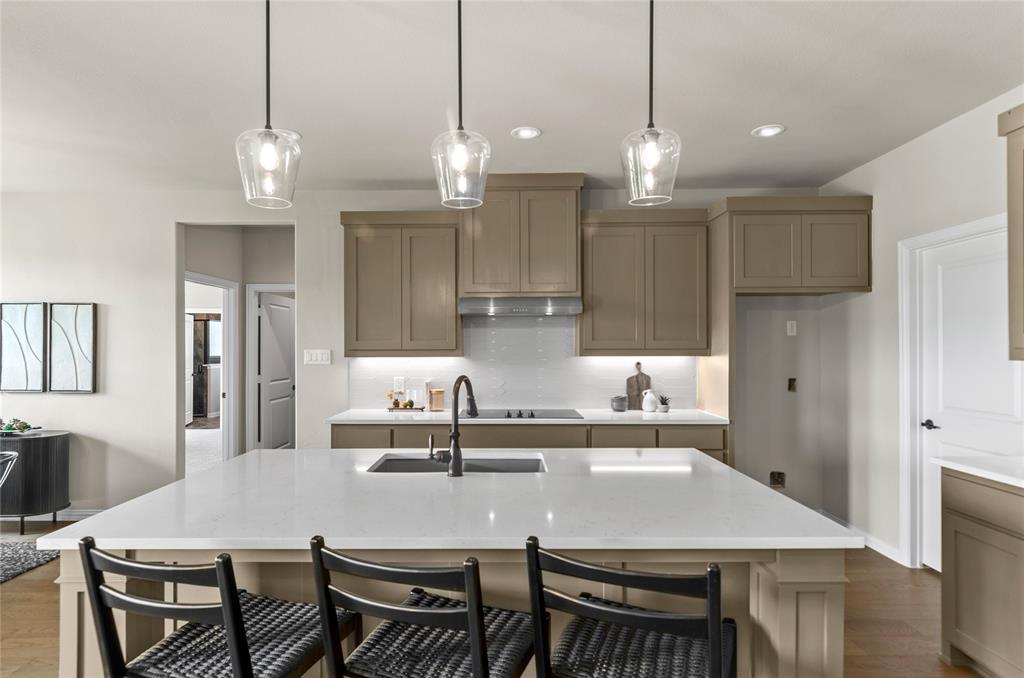205 Stuart Paradise, TX 76073 - Photo 13 of 33 a kitchen with kitchen island a dining table and chairs