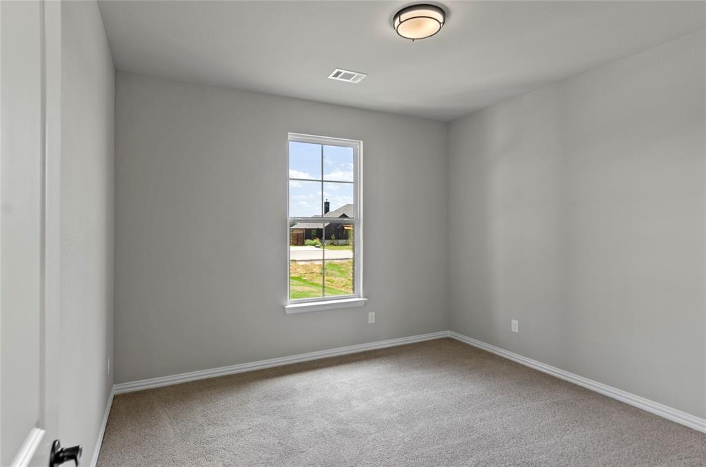 205 Stuart Paradise, TX 76073 - Photo 22 of 33 a view of an empty room and a window
