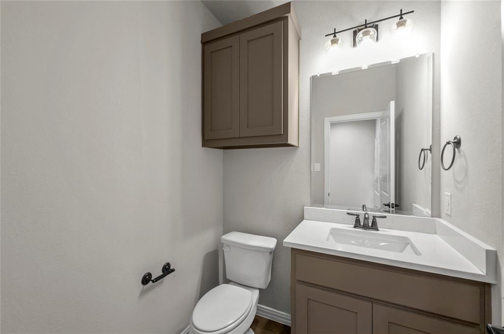 205 Stuart Paradise, TX 76073 - Photo 23 of 33 a bathroom with a sink toilet and mirror