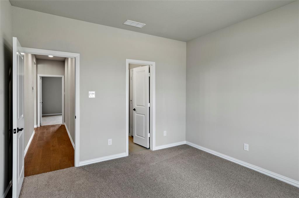 205 Stuart Paradise, TX 76073 - Photo 24 of 33 an empty room with closet and mirror