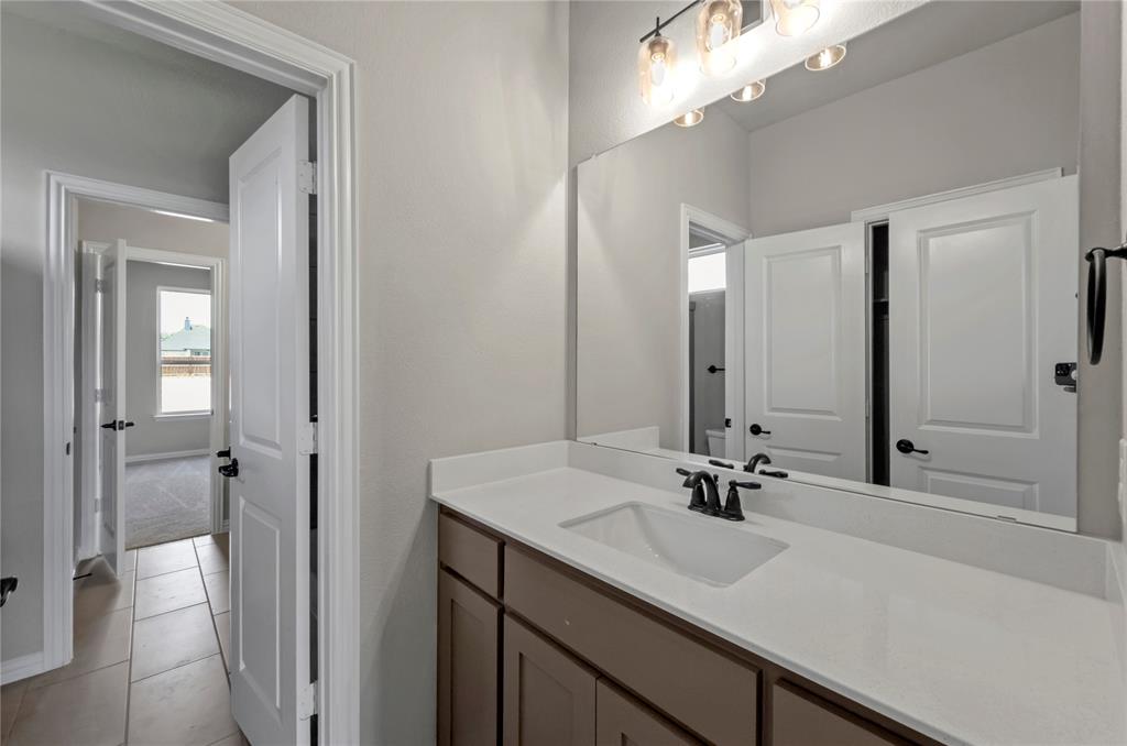 205 Stuart Paradise, TX 76073 - Photo 26 of 33 a bathroom with a sink and a mirror