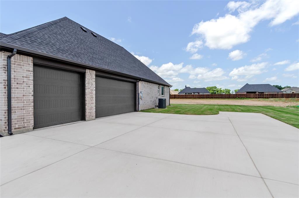 205 Stuart Paradise, TX 76073 - Photo 29 of 33 a house with outdoor space and trees in the background
