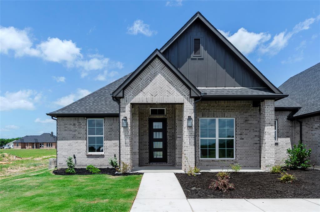 205 Stuart Paradise, TX 76073 - Photo 3 of 33 a front view of a house with a yard