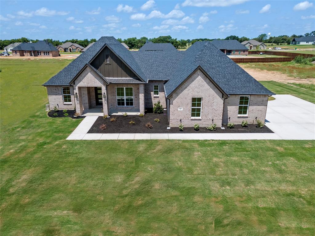 205 Stuart Paradise, TX 76073 - Photo 33 of 33 a front view of a house with a garden and lake view