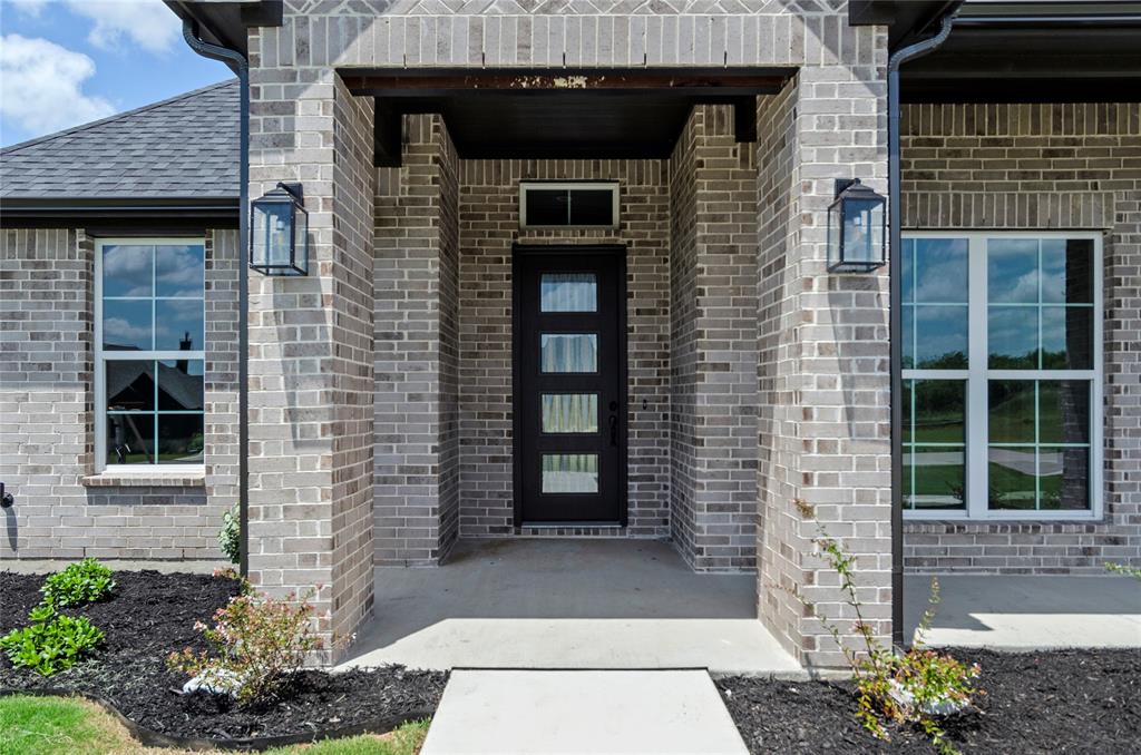 205 Stuart Paradise, TX 76073 - Photo 5 of 33 a front view of a house with a glass windows