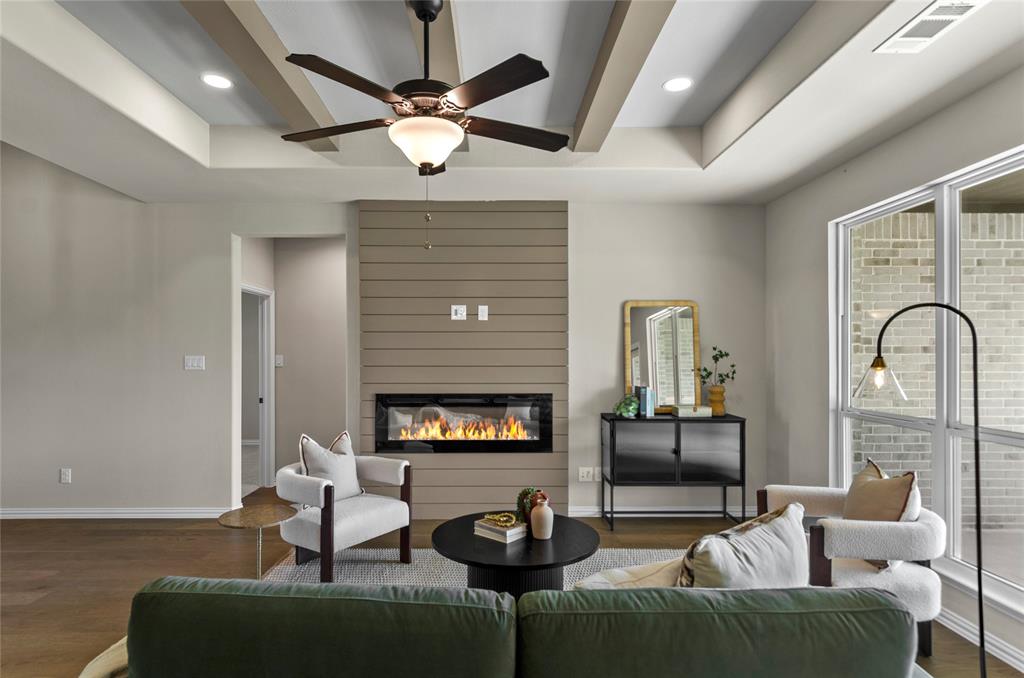 205 Stuart Paradise, TX 76073 - Photo 7 of 33 a living room with furniture a fireplace and a flat screen tv