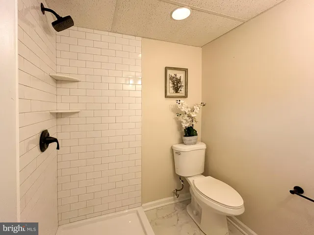 a white toilet sitting next to a bathroom sink