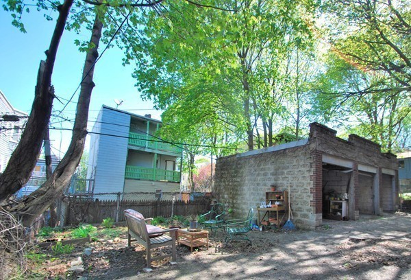 90 Montebello Road, Unit 3 Boston, MA 02130 - Photo 10 of 11 a front view of a house with a garden and sitting area