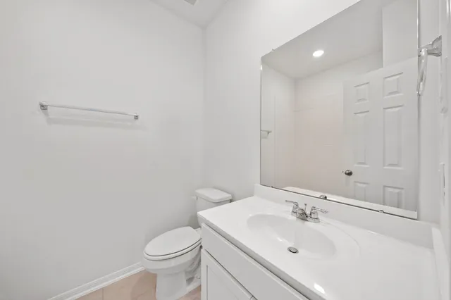 a bathroom with a sink toilet and vanity