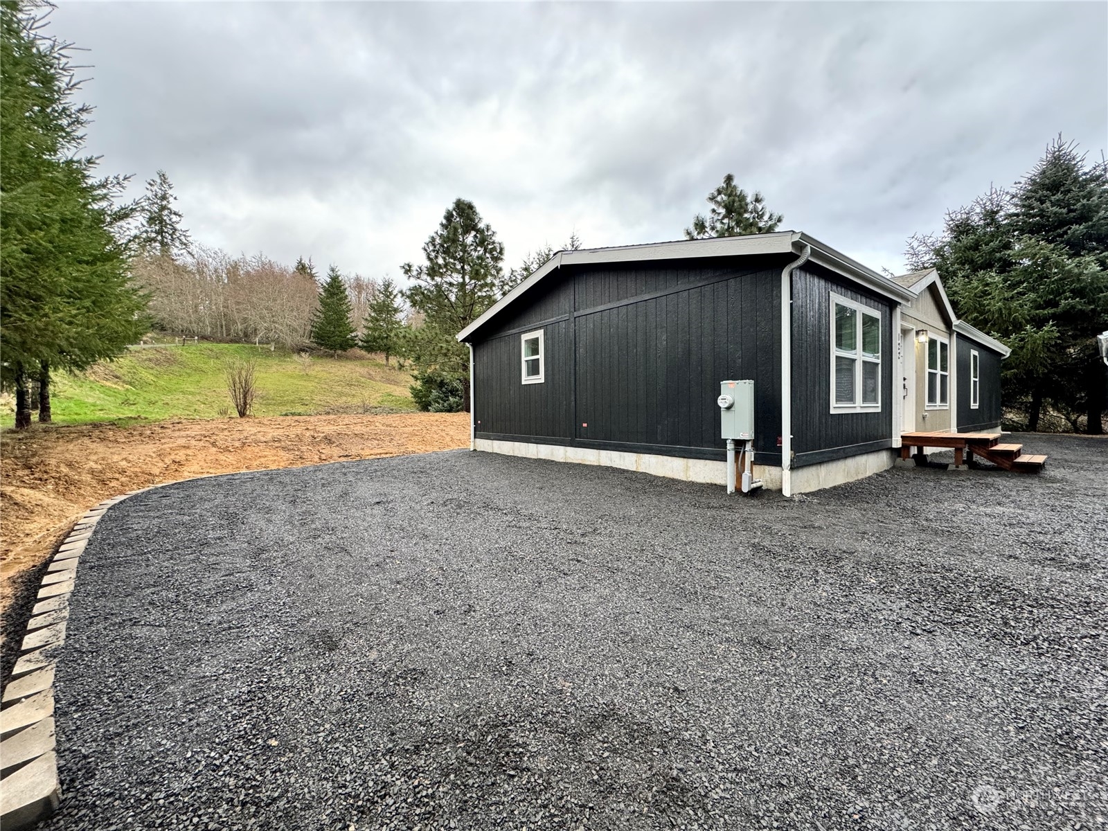 122 Ward Road Longview, WA 98632 - Photo 18 of 21 a house with trees in the background