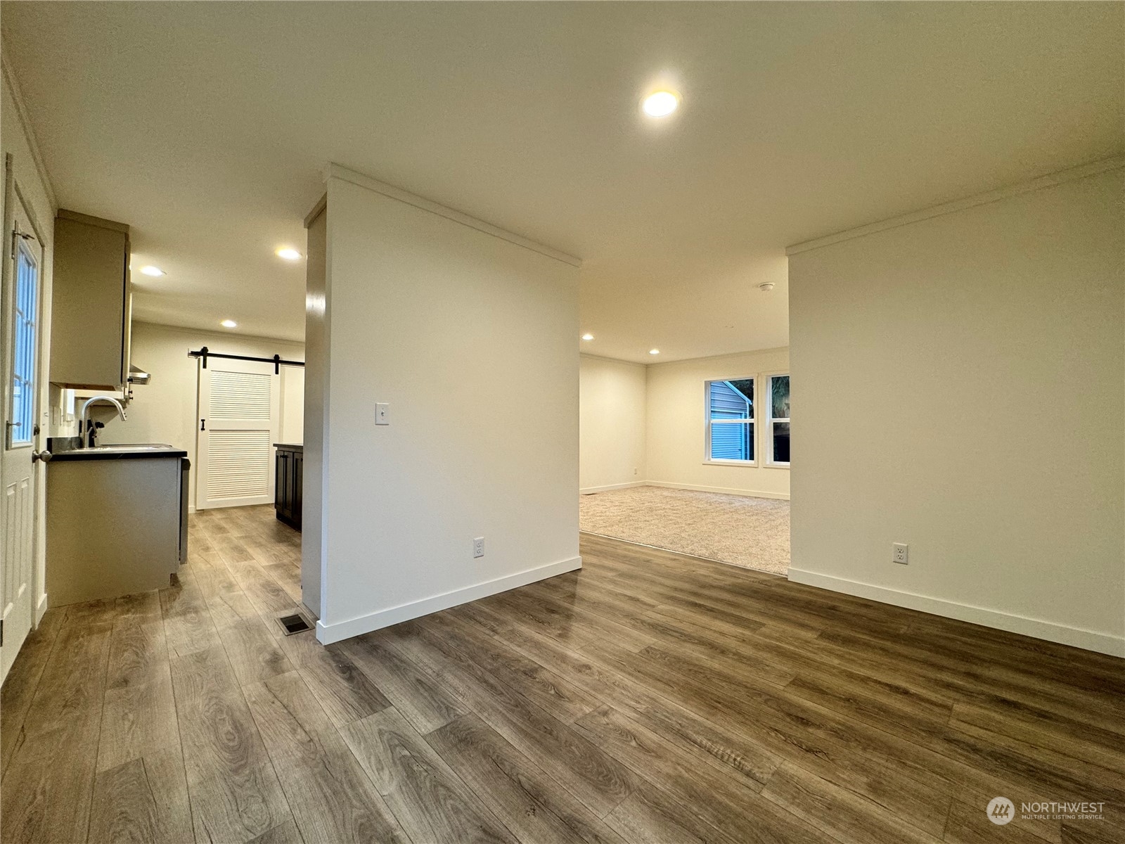 122 Ward Road Longview, WA 98632 - Photo 6 of 21 an empty room with wooden floor and windows