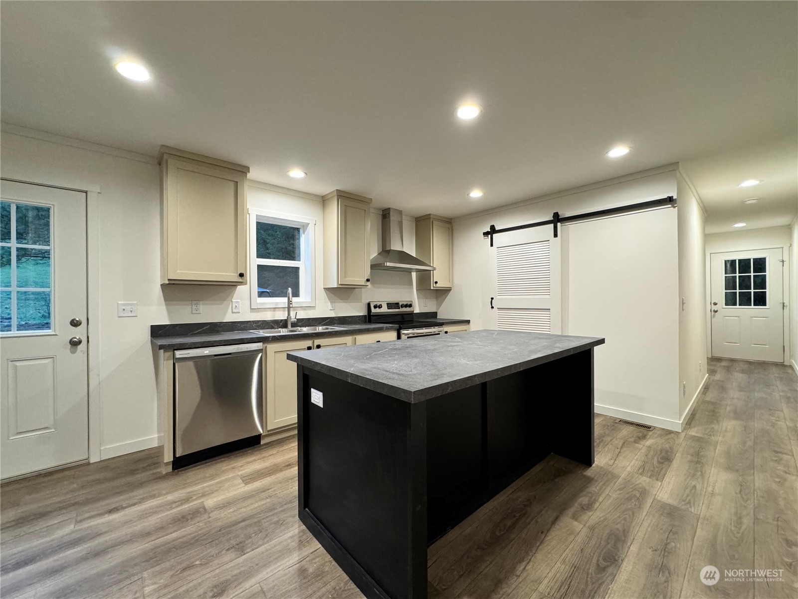 122 Ward Road Longview, WA 98632 - Photo 7 of 21 a kitchen with kitchen island granite countertop a sink and a stove top oven with wooden floor