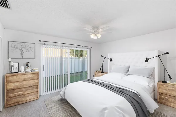 a bedroom with a bed a dresser with the wooden floor