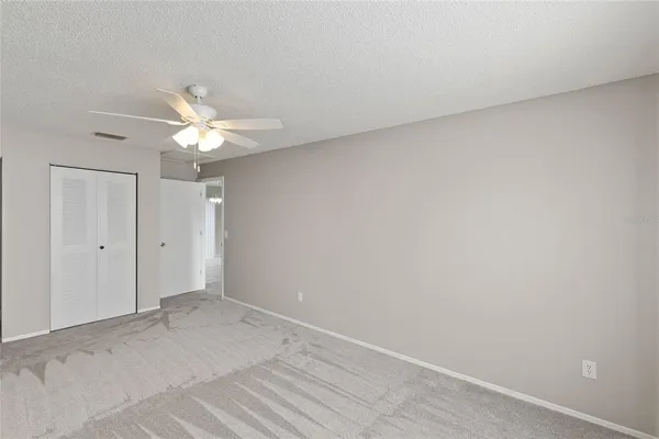 a view of a room with a fan and a window