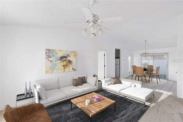 a living room with furniture and a chandelier