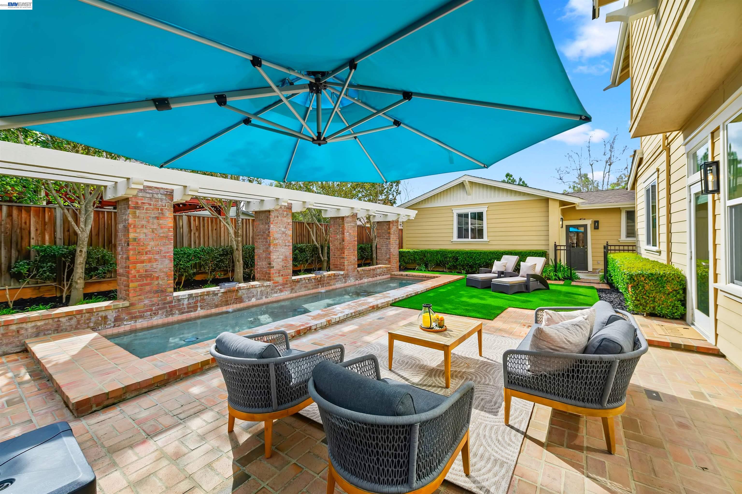 5454 Stockton Loop Livermore, CA 94550 - Photo 24 of 35 a view of a patio with table and chairs under an umbrella
