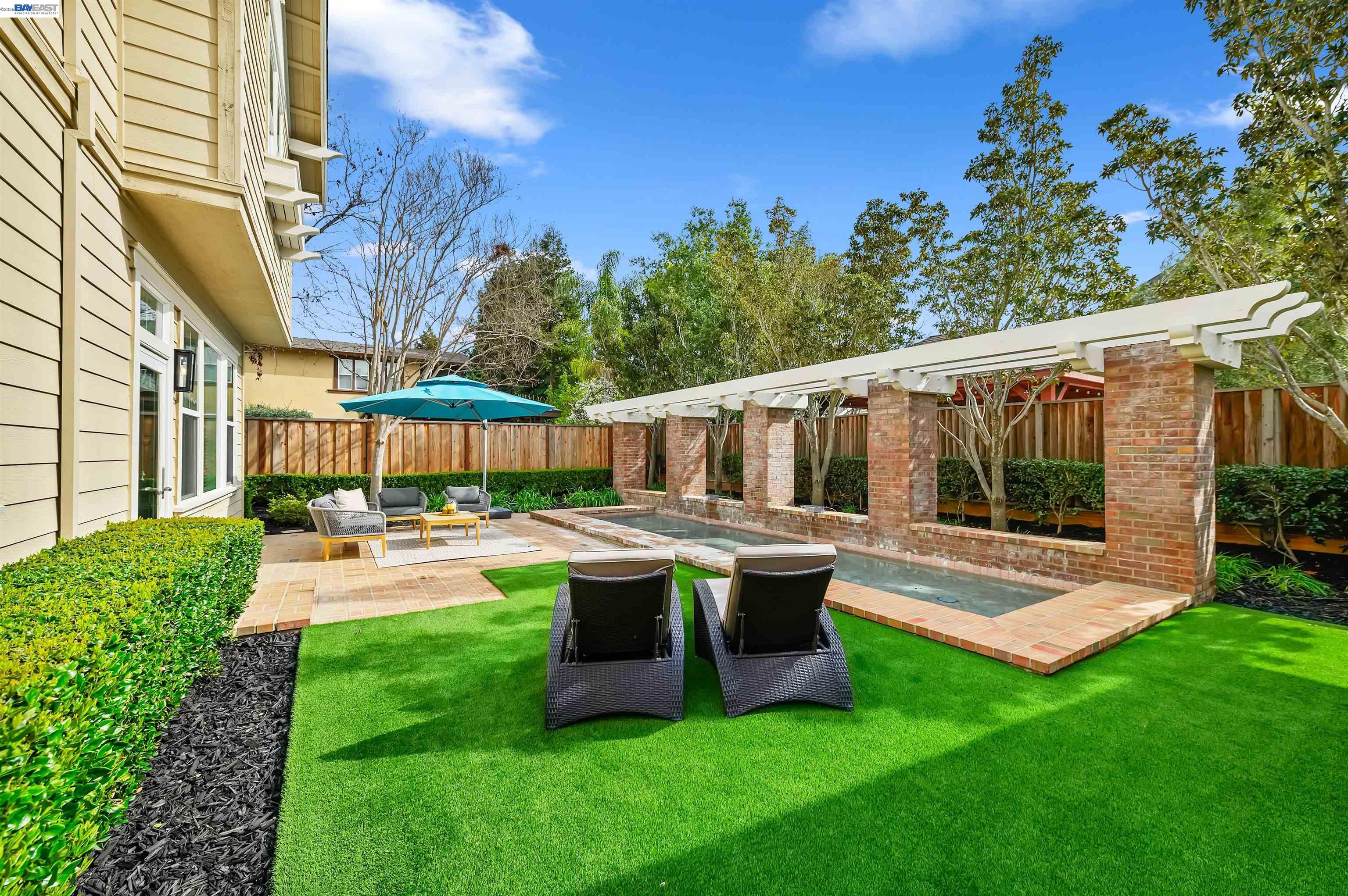 5454 Stockton Loop Livermore, CA 94550 - Photo 28 of 35 a view of a patio with table and chairs potted plants with wooden floor and fence
