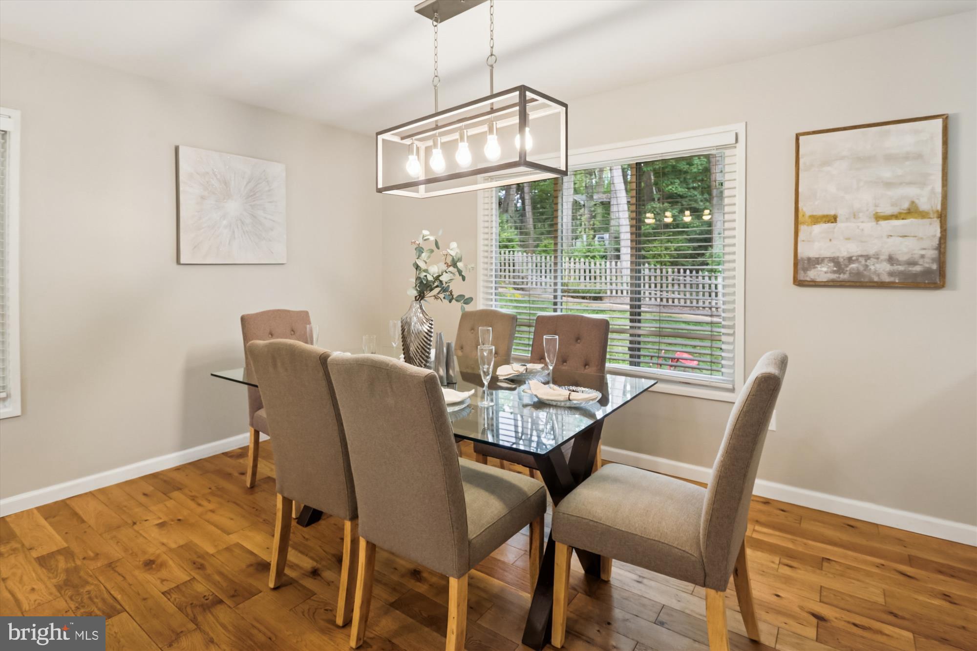 10105 Meredith Avenue Silver Spring, MD 20910 - Photo 11 of 76 a dining room with furniture a chandelier and wooden floor