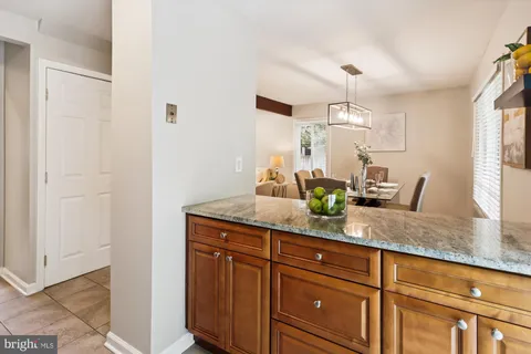 a view of a hallway with wooden floor and a cabinet