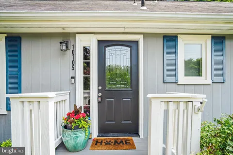 a living room with furniture a rug and a window