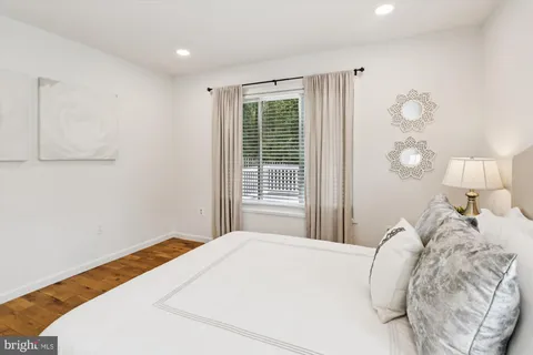 a bedroom with a bed and a mirror