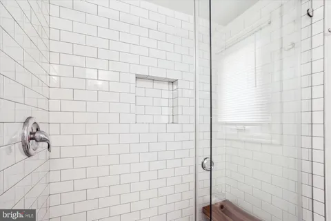 a bedroom with a bed and a fan