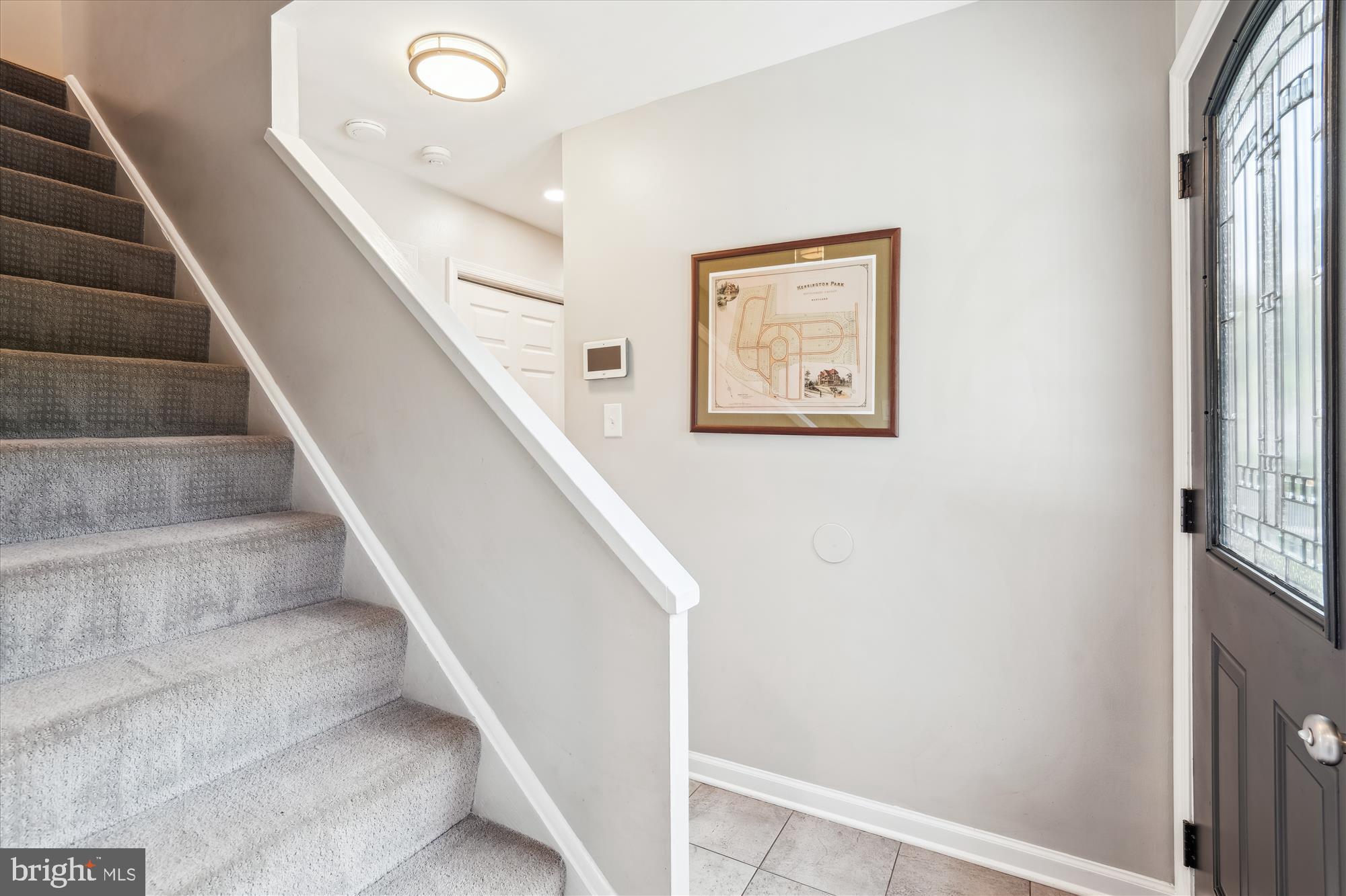 10105 Meredith Avenue Silver Spring, MD 20910 - Photo 32 of 76 a view of staircase with lots of frames on wall and a window