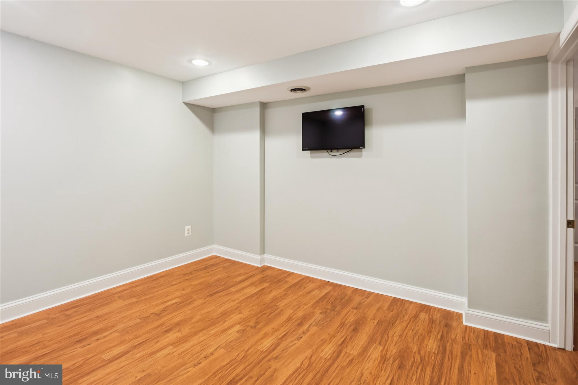 10105 Meredith Avenue Silver Spring, MD 20910 - Photo 49 of 76 a view of an empty room with wooden floor and a window