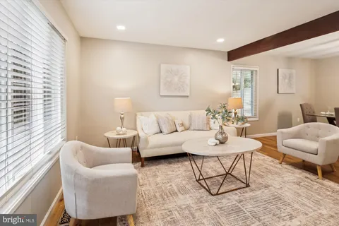 a living room with furniture or wooden floor and a large window