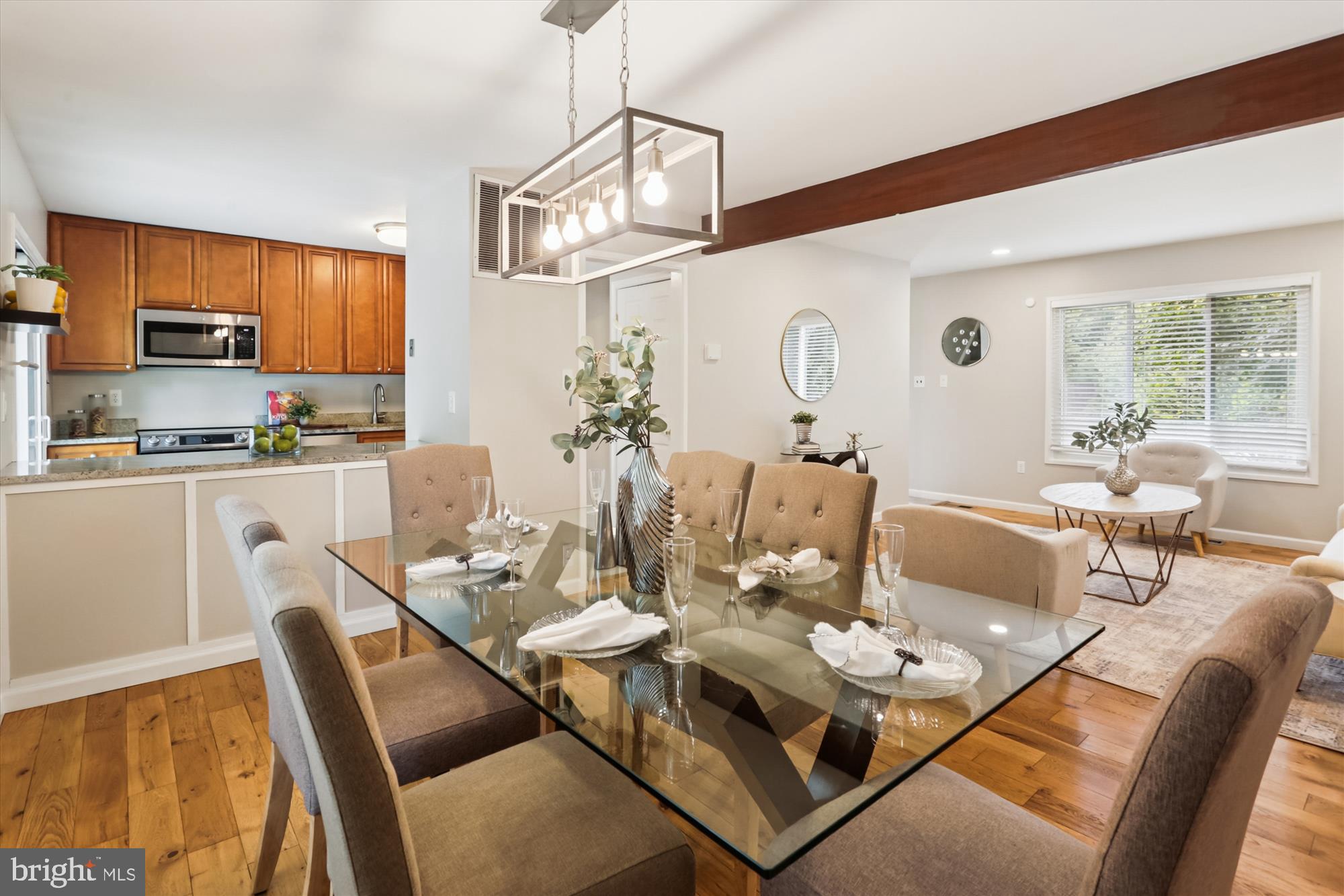 10105 Meredith Avenue Silver Spring, MD 20910 - Photo 9 of 76 a dining room with wooden floor a chandelier a wooden table and chairs