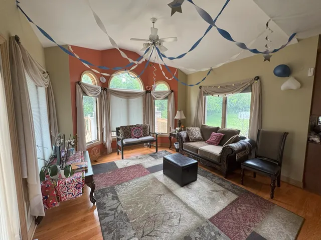 en empty room with windows and fan