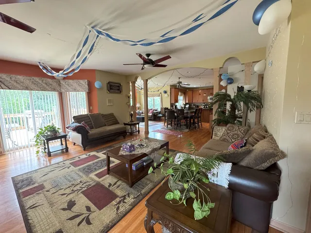 a living room with a couch and dresser with wooden floor