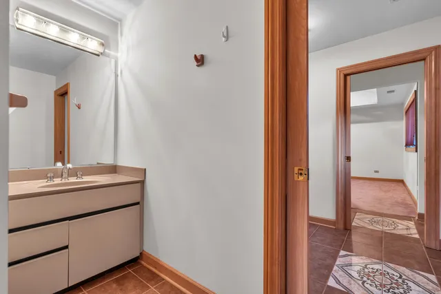 a kitchen with kitchen island granite countertop wooden floors and a sink