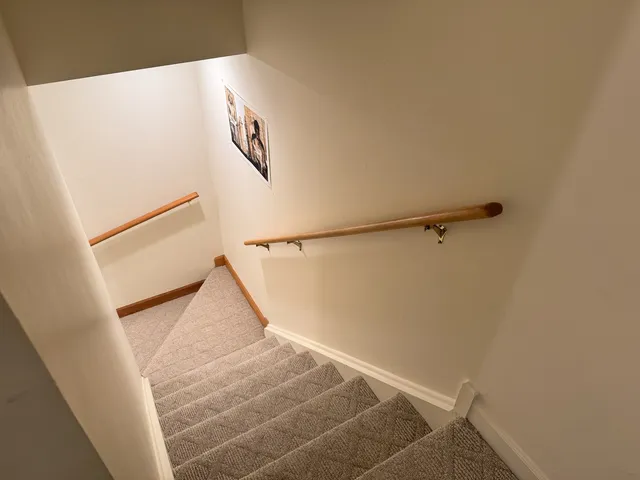 a front view of a house with a yard and trees