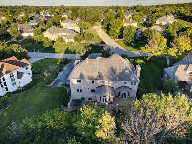 an aerial view of a house with a yard