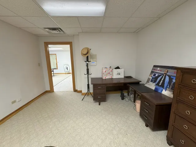 an aerial view of house with yard and trees in the background