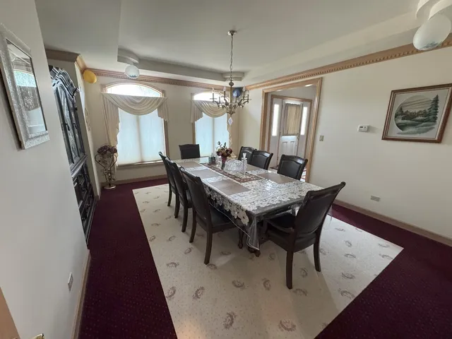 a view of a dining room and livingroom with furniture wooden floor and chandelier