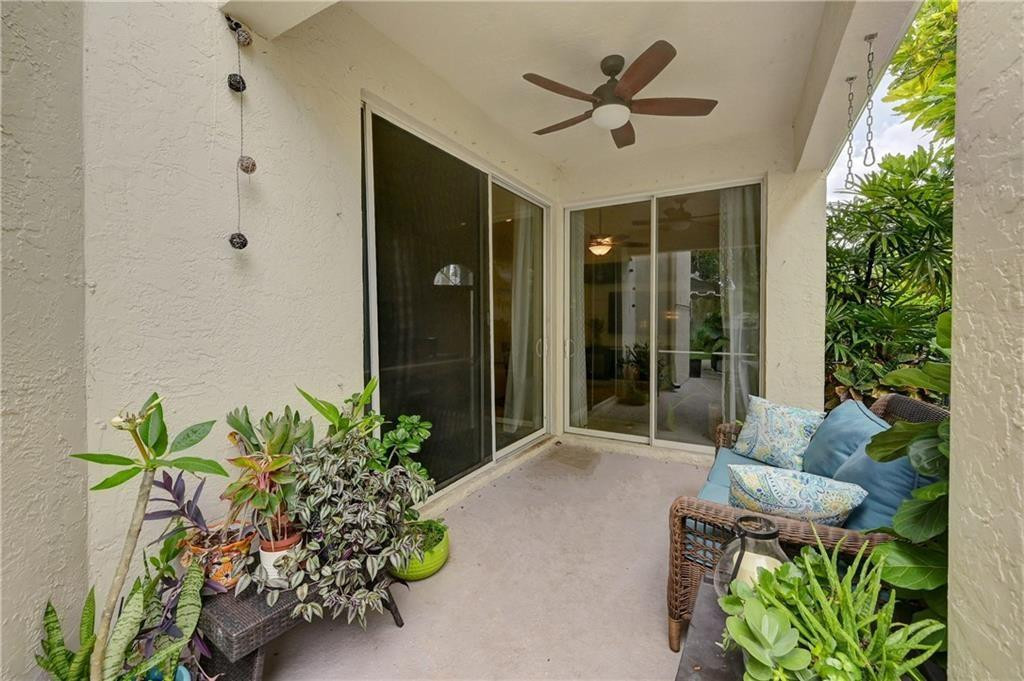 8171 Hampton Wood Drive Boca Raton, FL 33433 - Photo 24 of 56 a porch with a table and a potted plant